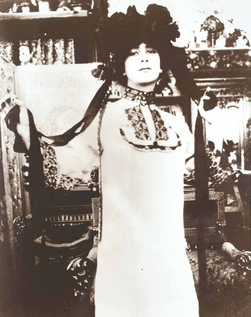 Model in a White Robe with a Hat with Ribbons